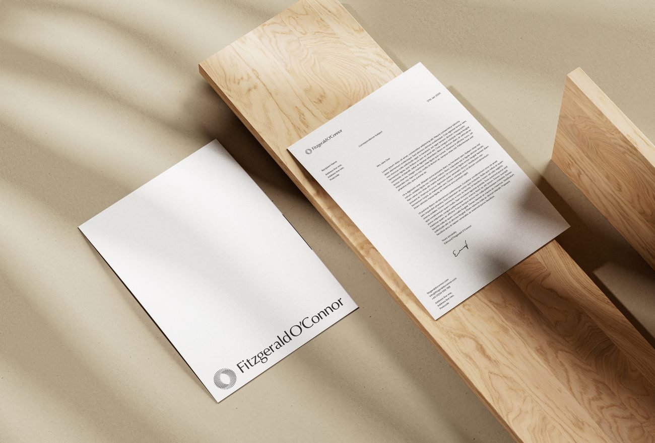 Flat lay of branded stationery with the Fitzgerald O’Connor logo, demonstrating premium reconstructive plastic surgery branding.