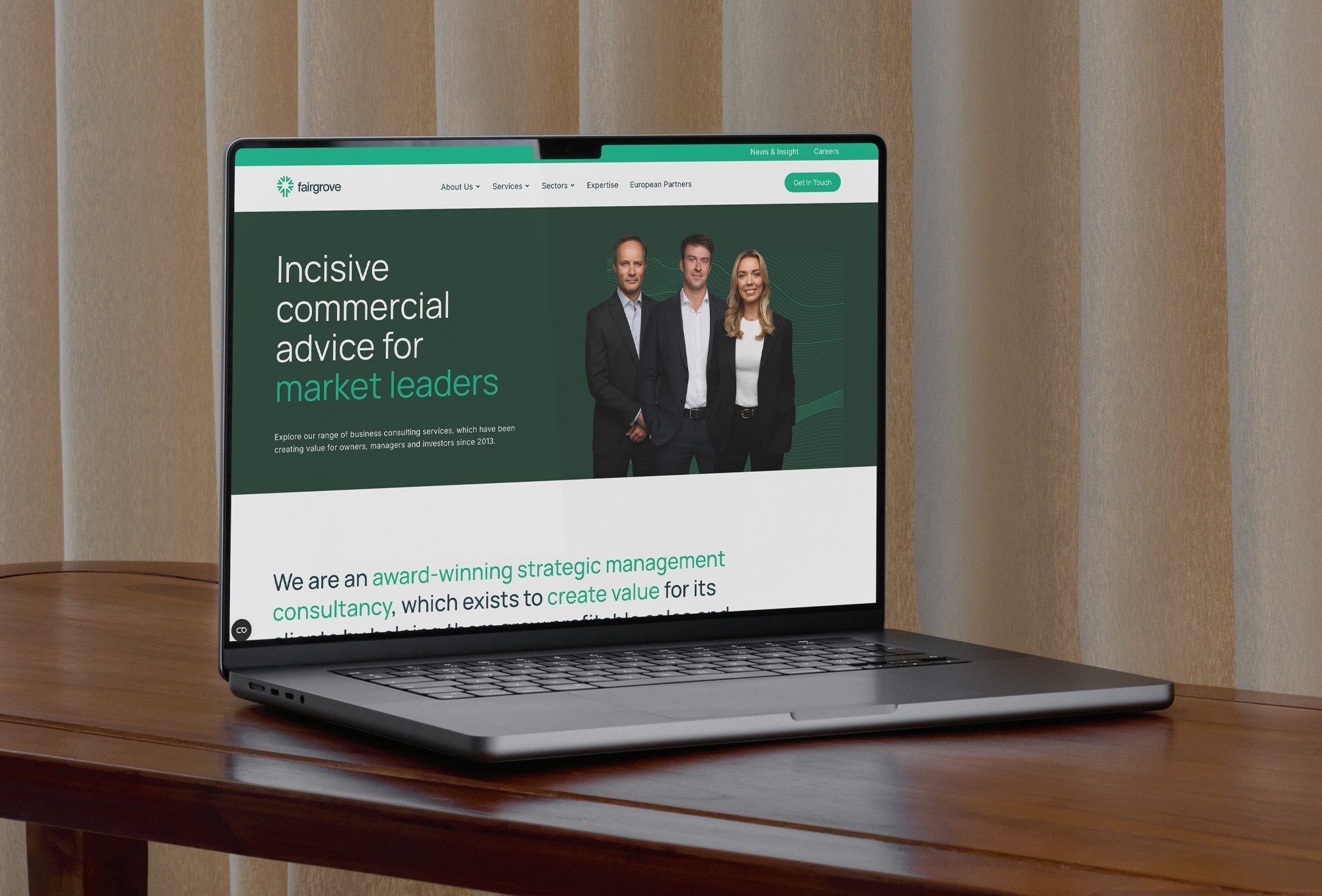 Website design for Fairgrove Partners consultancy displayed on a laptop.
